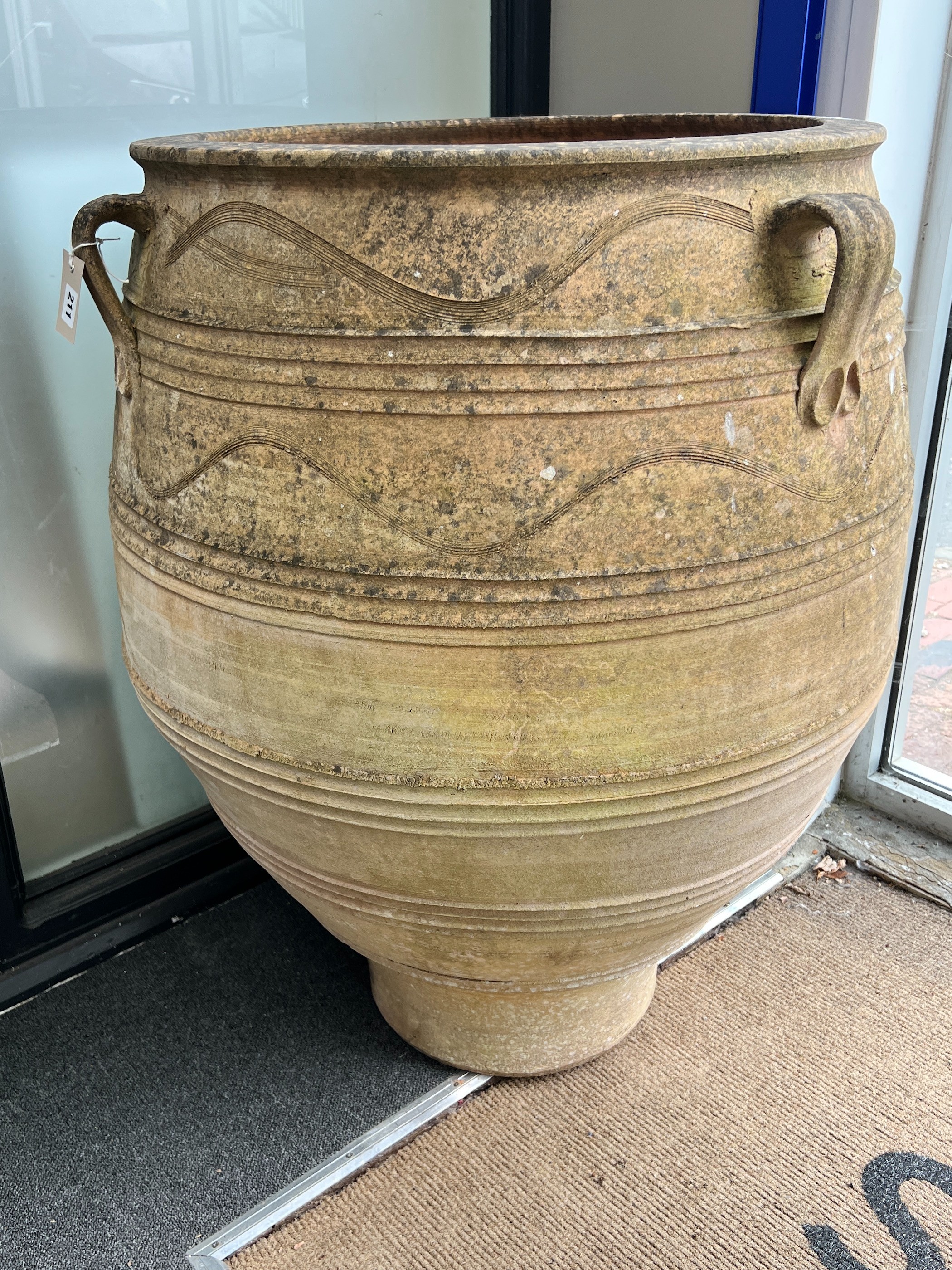 A large Grecian style incised terracotta oil jar, height 99cm